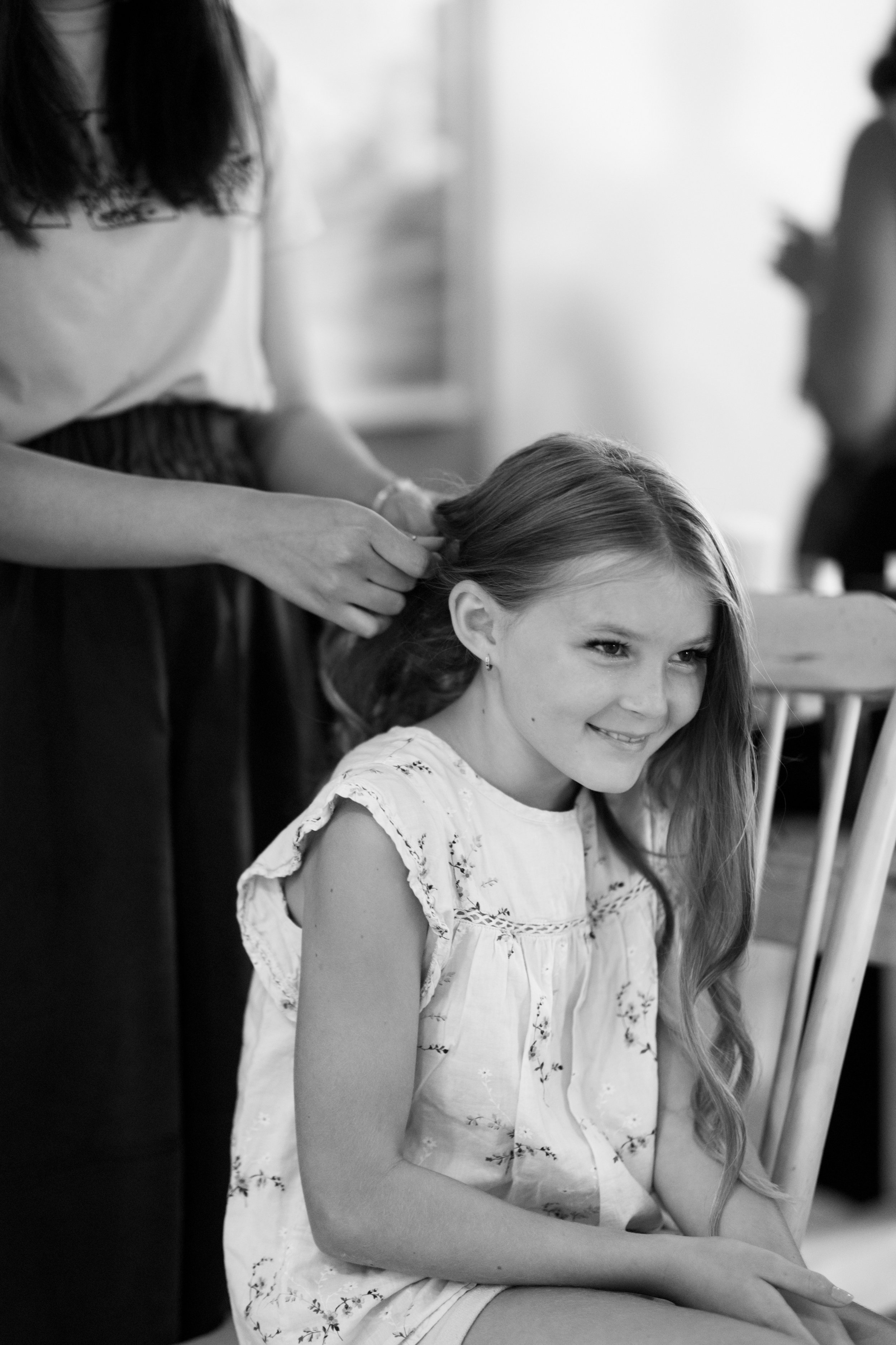 The flower girl getting her hair done with Maureen.