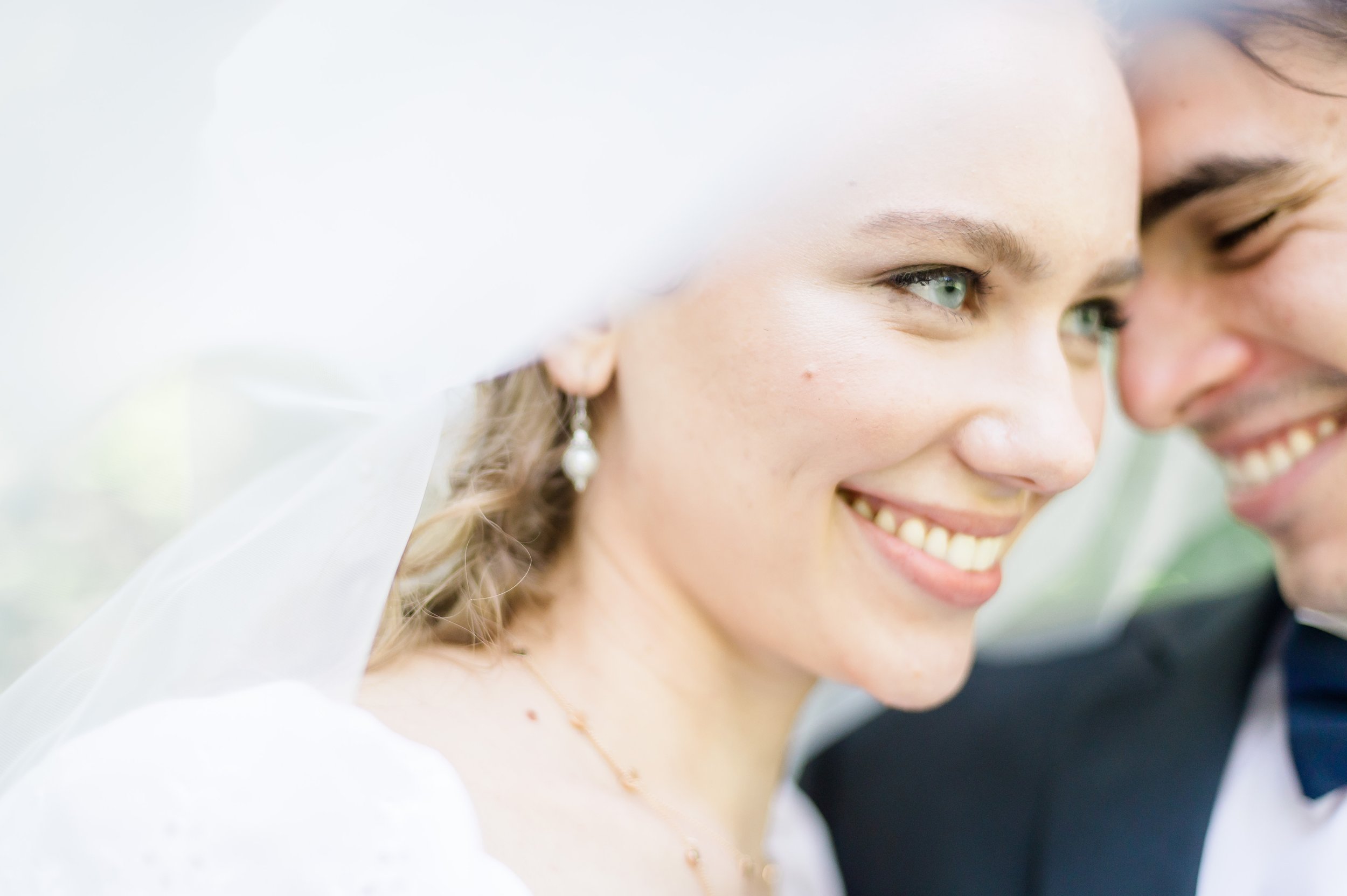 Smiling Simone under her veil, looking beautiful bridal and sunny.