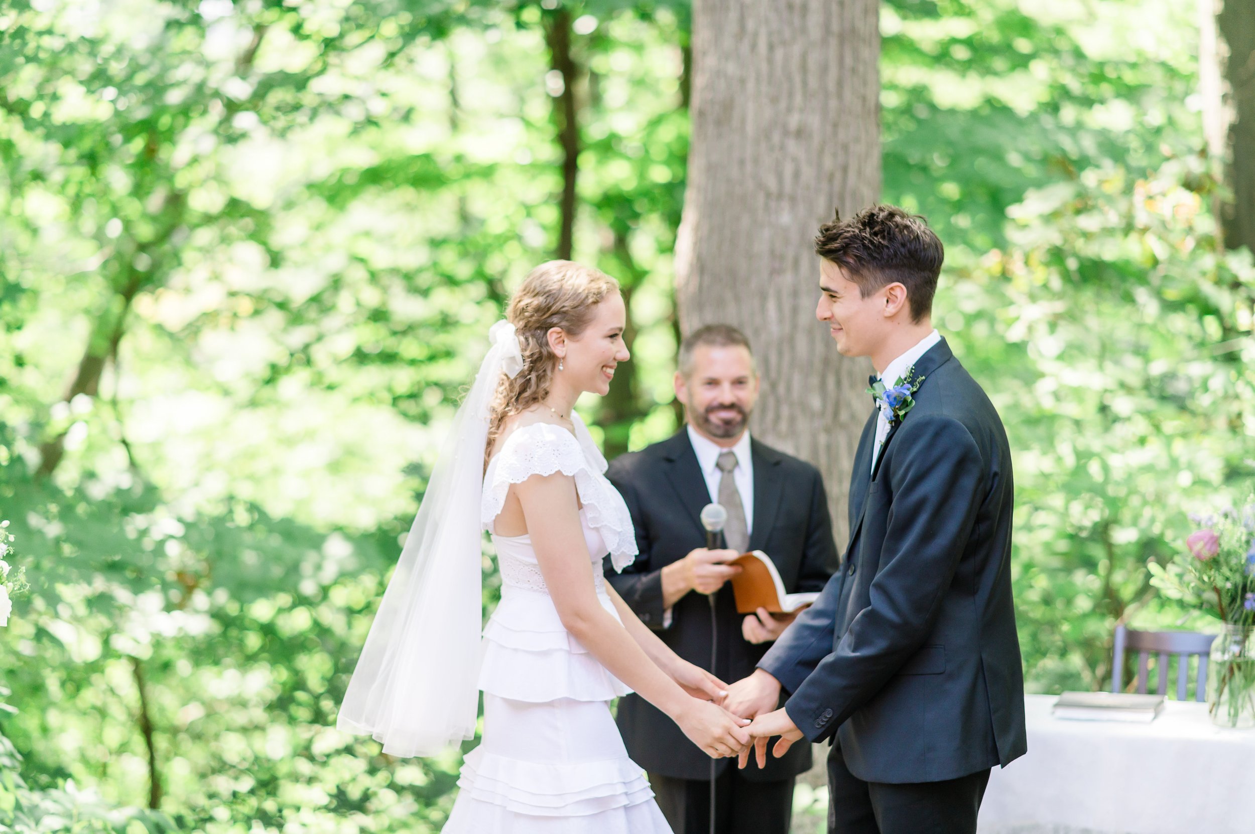 bride and groom under the trees