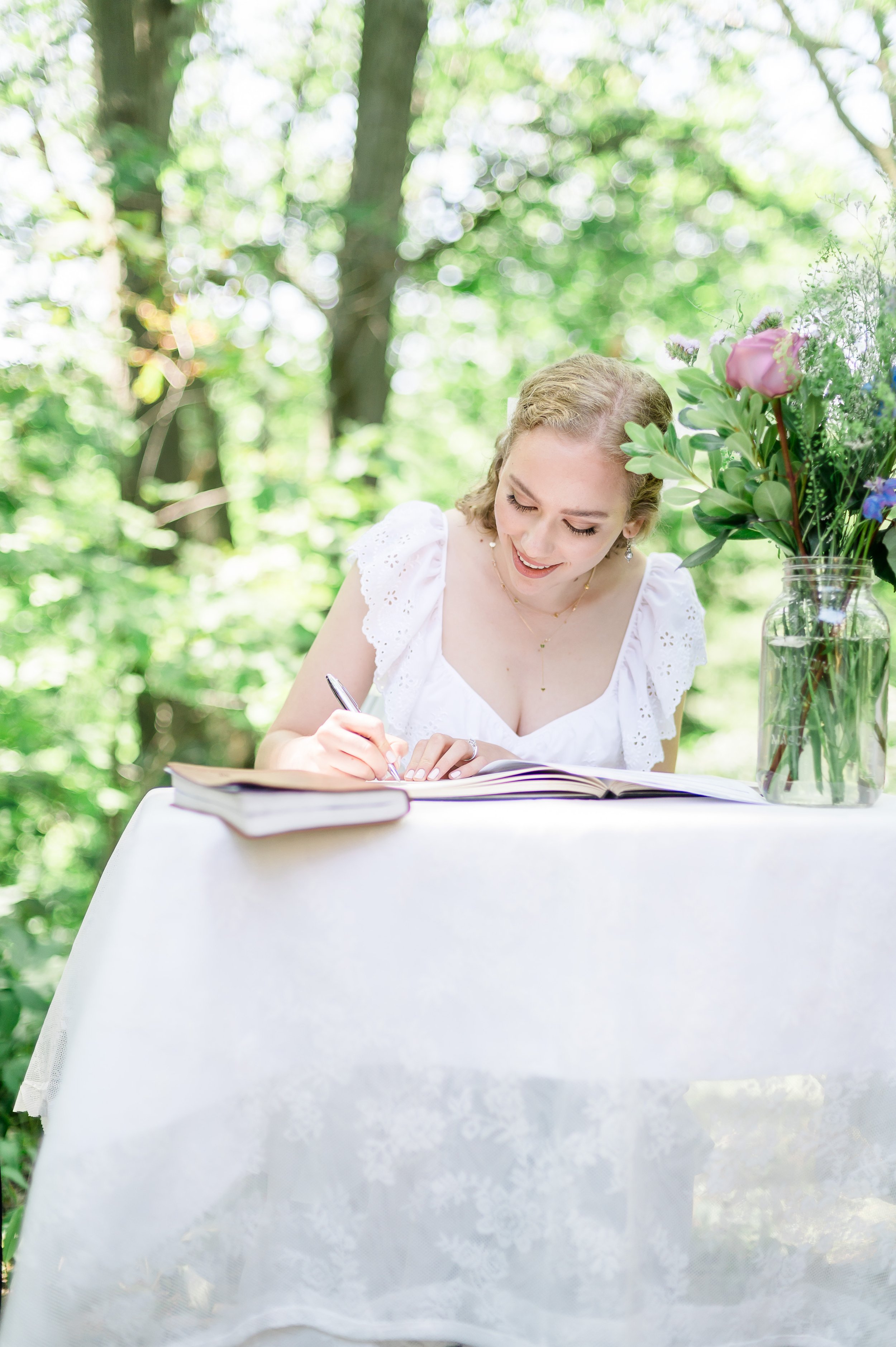 bride is signing the wedding papers