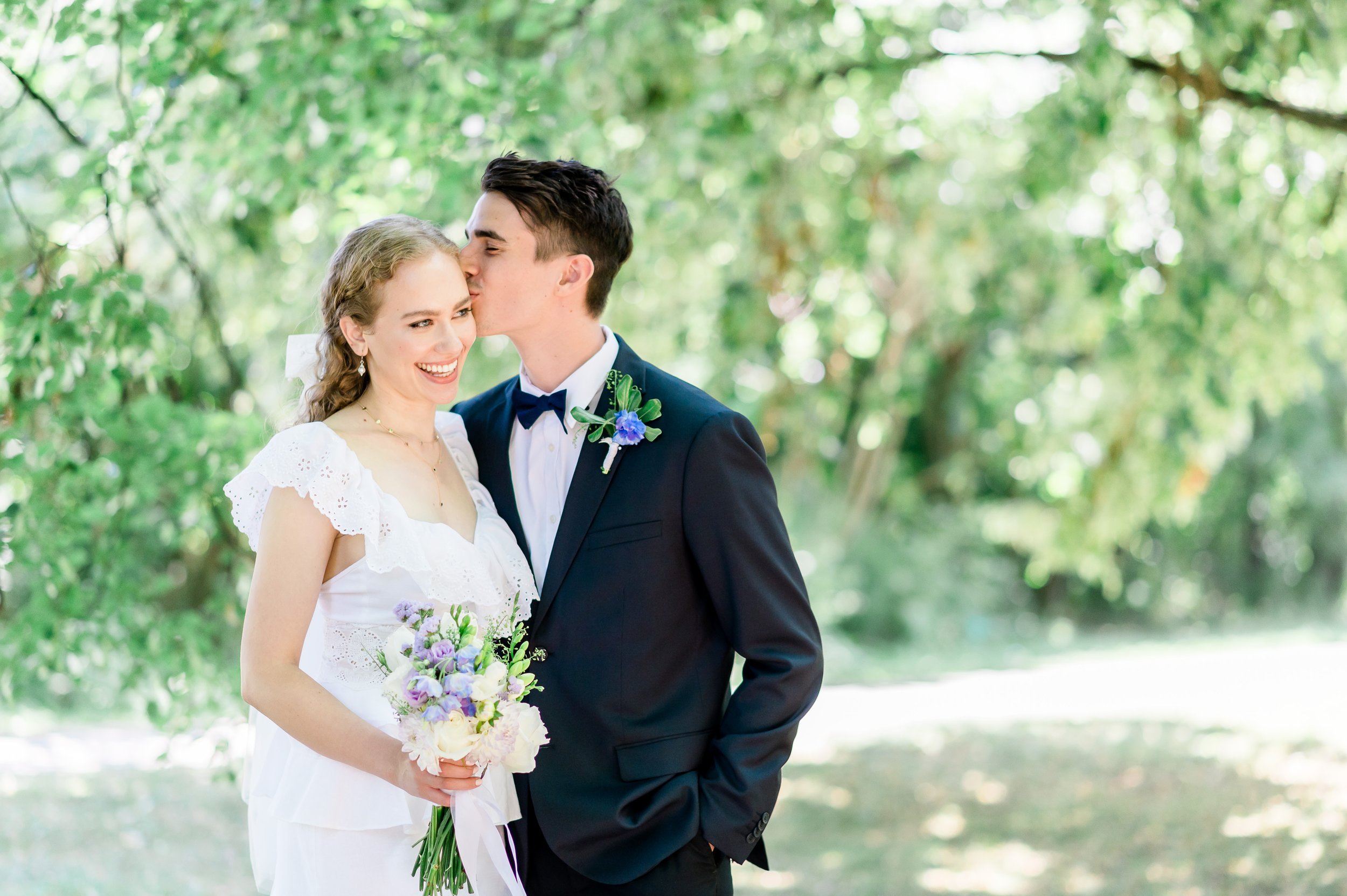 kissing under a canopy of trees