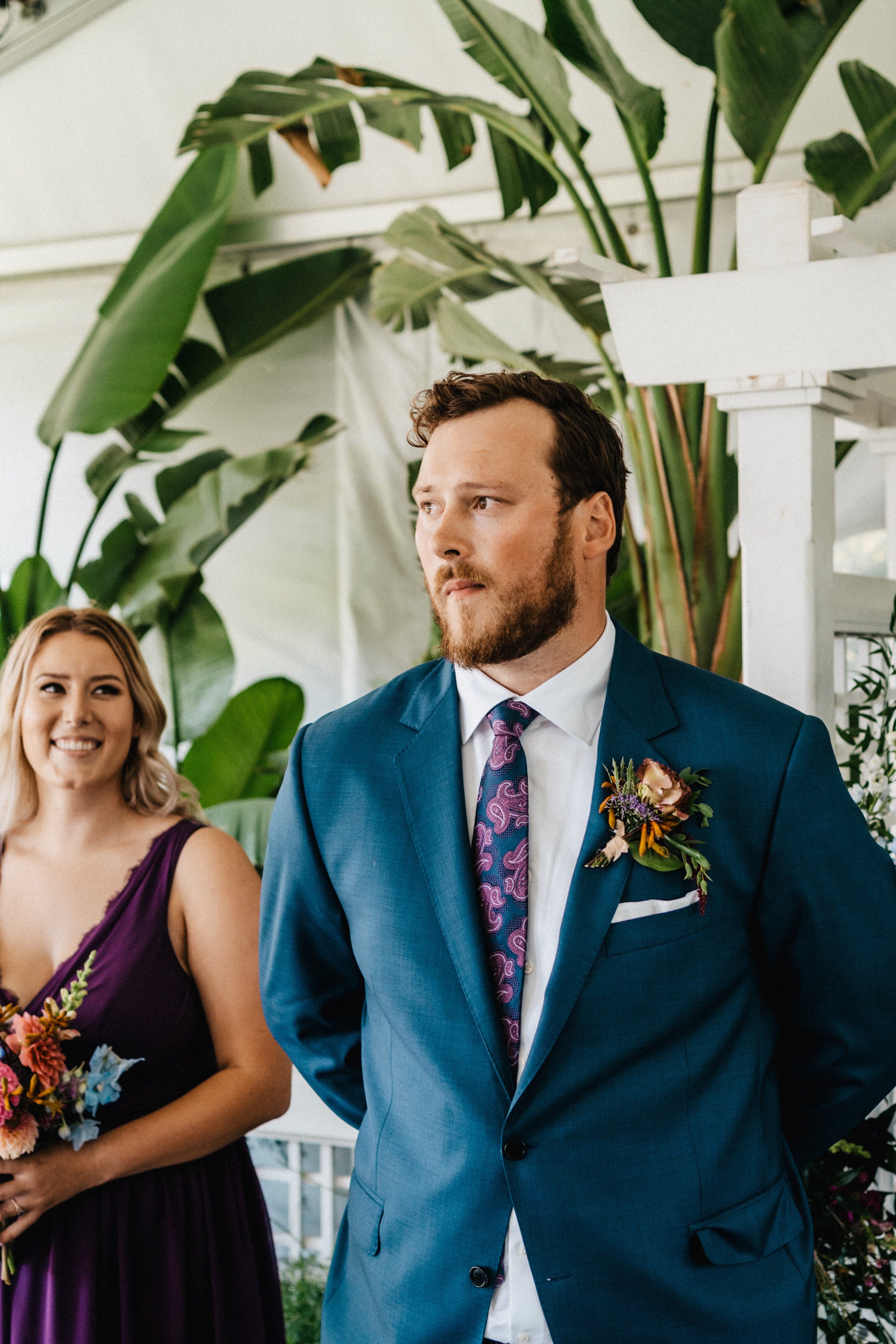 the groom anxiously awaiting his bride! The groom's sister looks on smiling.