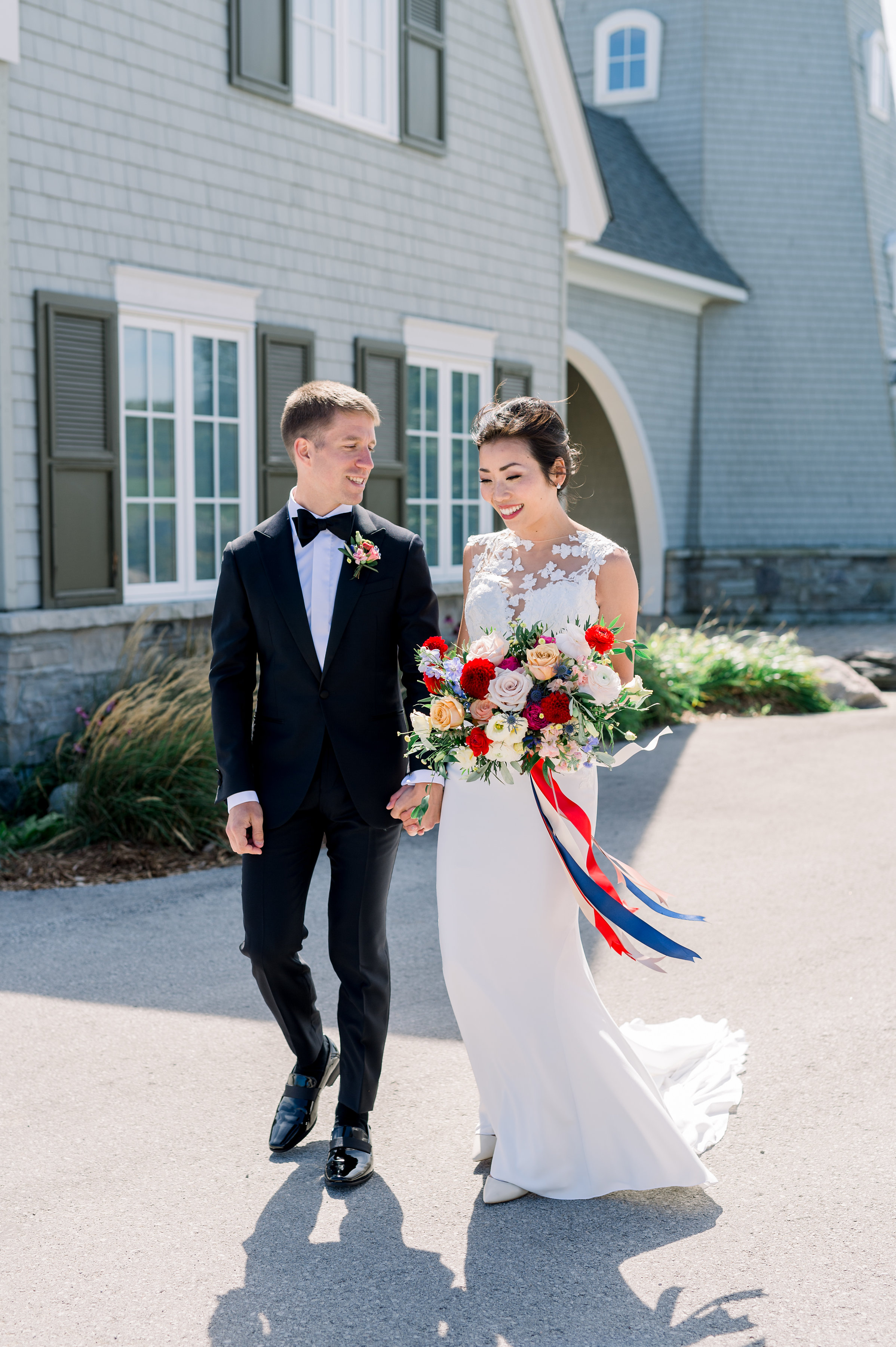 The bride and groom near the lighthouse. Photo courtesy of Whitney Heard. Bride’s makeup by Maya Goldenberg, hair by Shanna Layton for Maya Goldenberg, Eco-Beauty Professional. Flowers by Tina from Living Fresh.