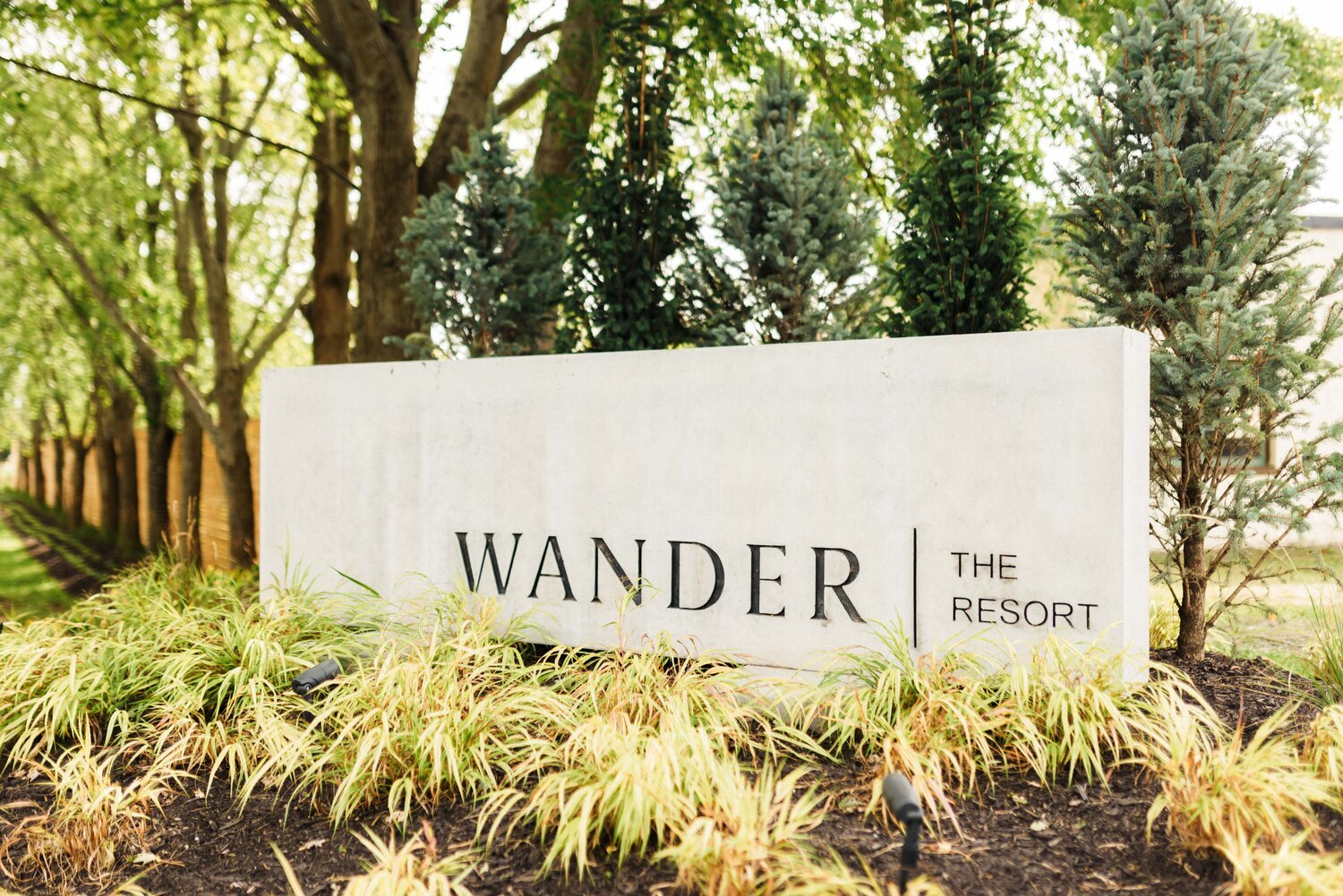 A view of the entrance marker- a cement stone with 'Wander The Resort' written on it. A lovely venue in Prince Edward County.