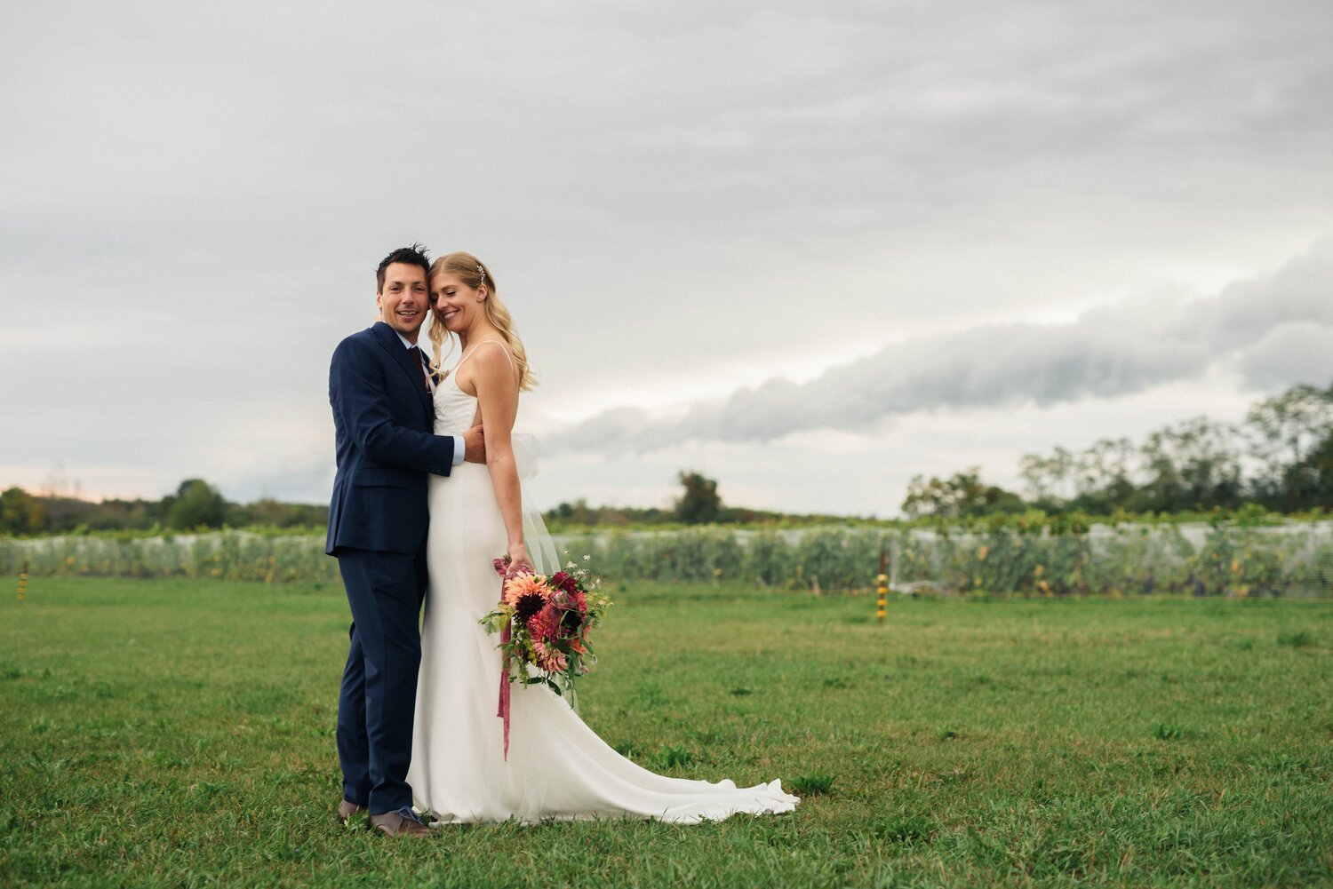 The happy couple, under the wide open sky, in a field near the Old Third, in Prince Edward County.