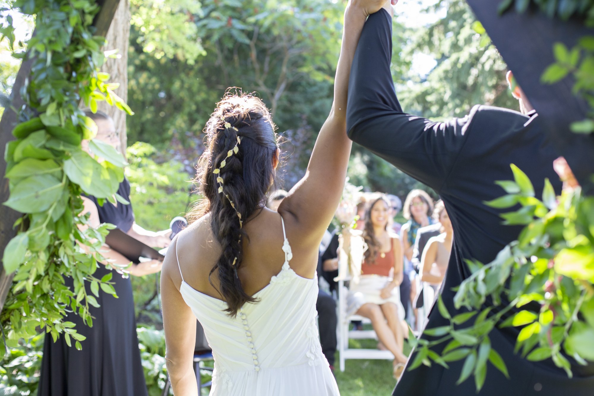 The happy couple hold up their hands- hand in hand- symbolizing their union.