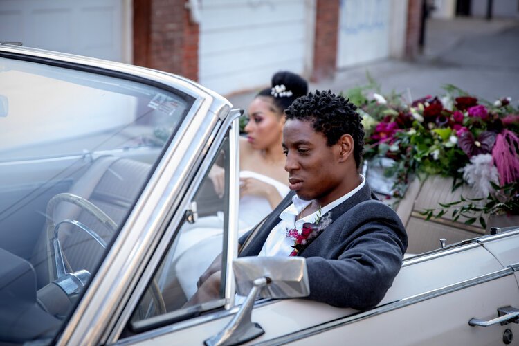 bride and groom in a vintage car.